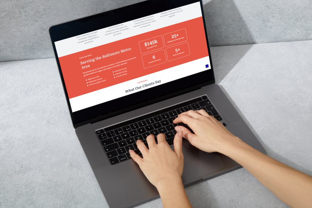 Laptop displaying website for Baltimore Metro remodeling services with renovation statistics